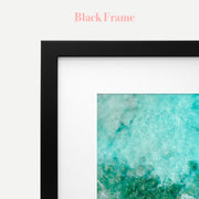 a black frame with a picture of the ocean