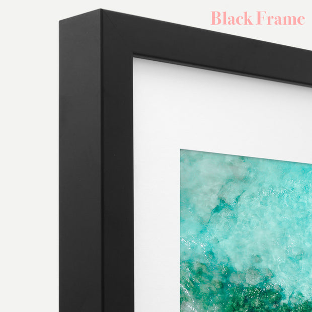 a black frame with a picture of a blue and green painting